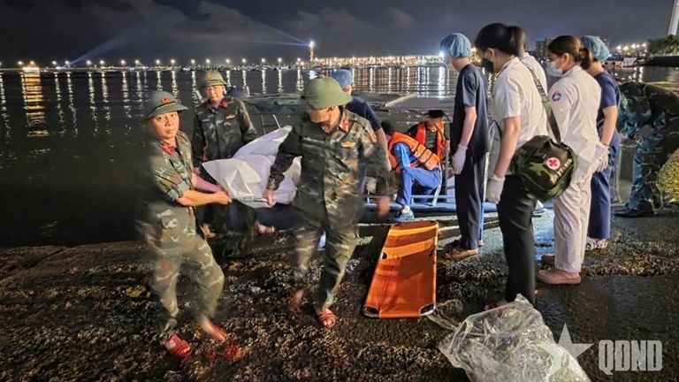 A body being carried on stretcher after a tourist boat capsized in Ha Long Bay, Vietnam. Pic: QDND via AP