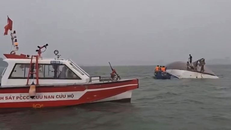People on a capsized tourist boat being rescued in Ha Long Bay, Vietnam. Pic: QDND via AP