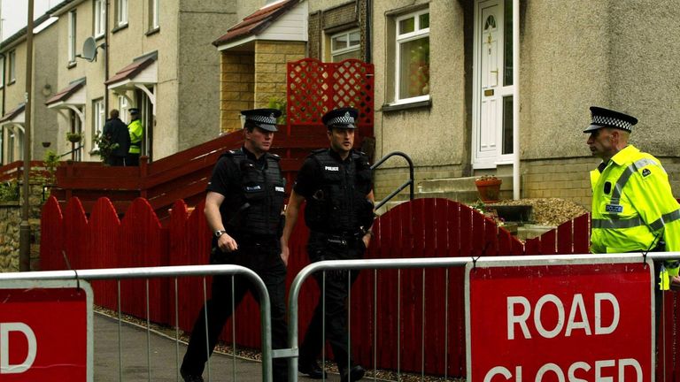 Police Officers outside the former house of Peter Tobin on Robertson Avenue, Bathgate.
