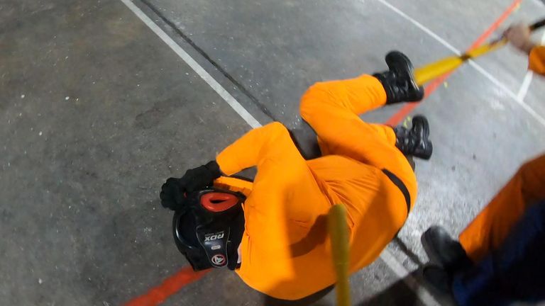 An 'inmate' is tackled by a security officer during a role-play demostration