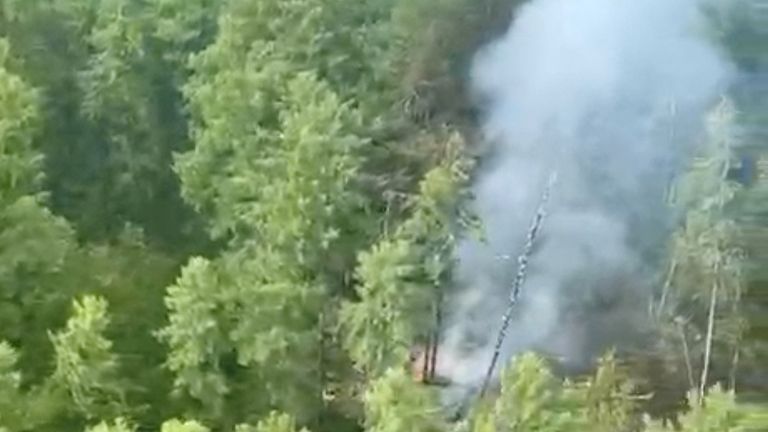 Smoke rises at the crash site of an Angara Airlines An-24 passenger plane near Tynda.
Pic: Federal Air Transport agency/Reuters