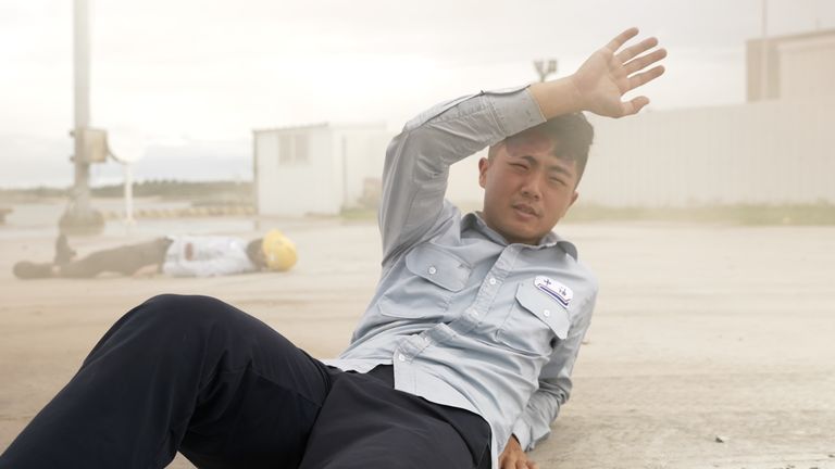A man feigns injury during a drill, simulating an explosion at a port on the Taiwanese island of Penghu