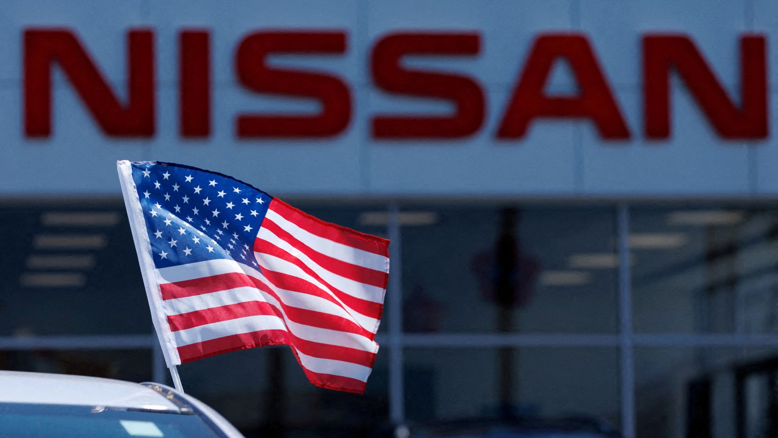 American flag is on a vehicle at a Nissan dealership in California. Pic: Reuters