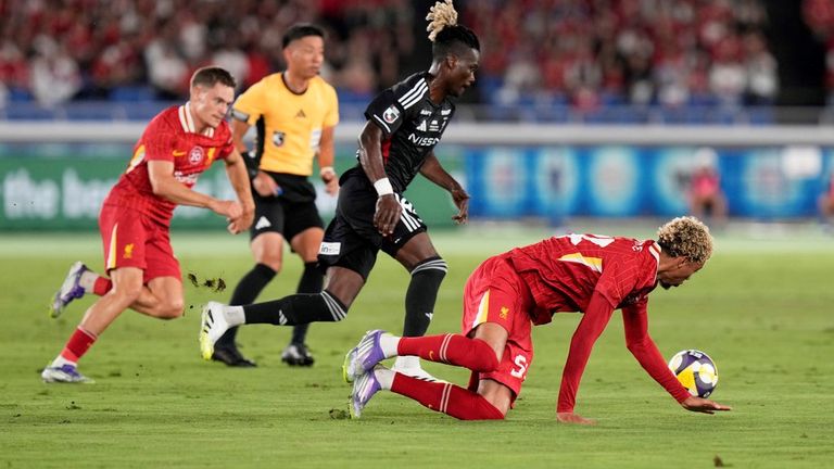 Liverpool's Hugo Ekitike, right, loses balance as he battles for the ball against Yokohama F. Marinos