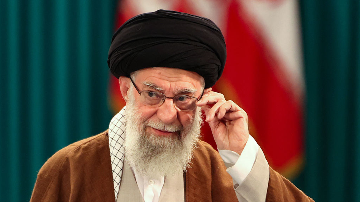 Iranian Supreme Leader Ayatollah Ali Khamenei fixing his glasses