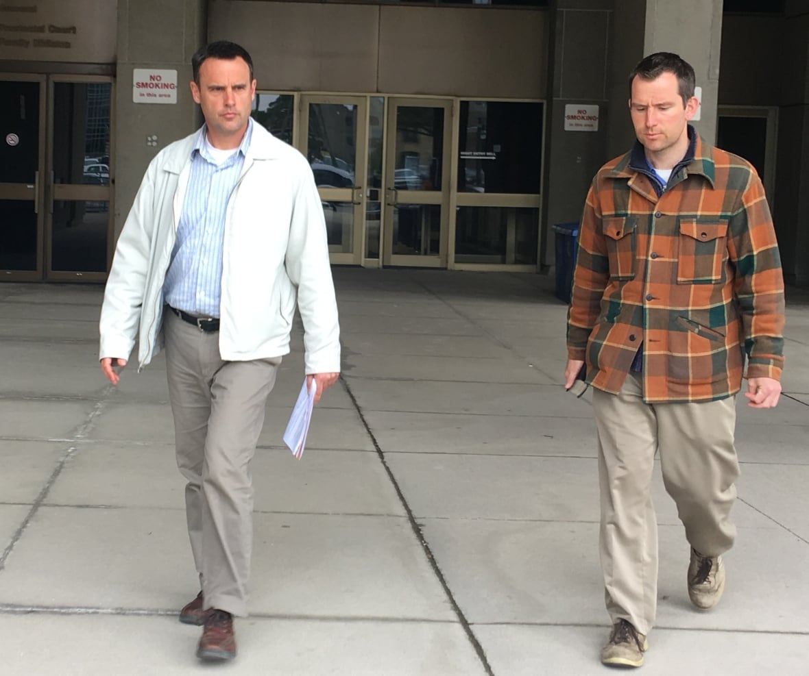 Steven Ravbar, 50, and Matthew Carapella, 32, leave the Ontario Court of Justice on Monday after making a brief appearance on mischief charges. 