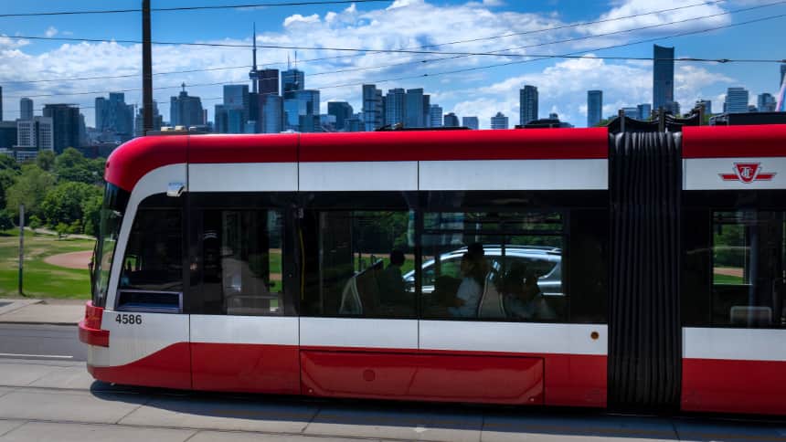 A red and white streetcar in the city of Toronto.