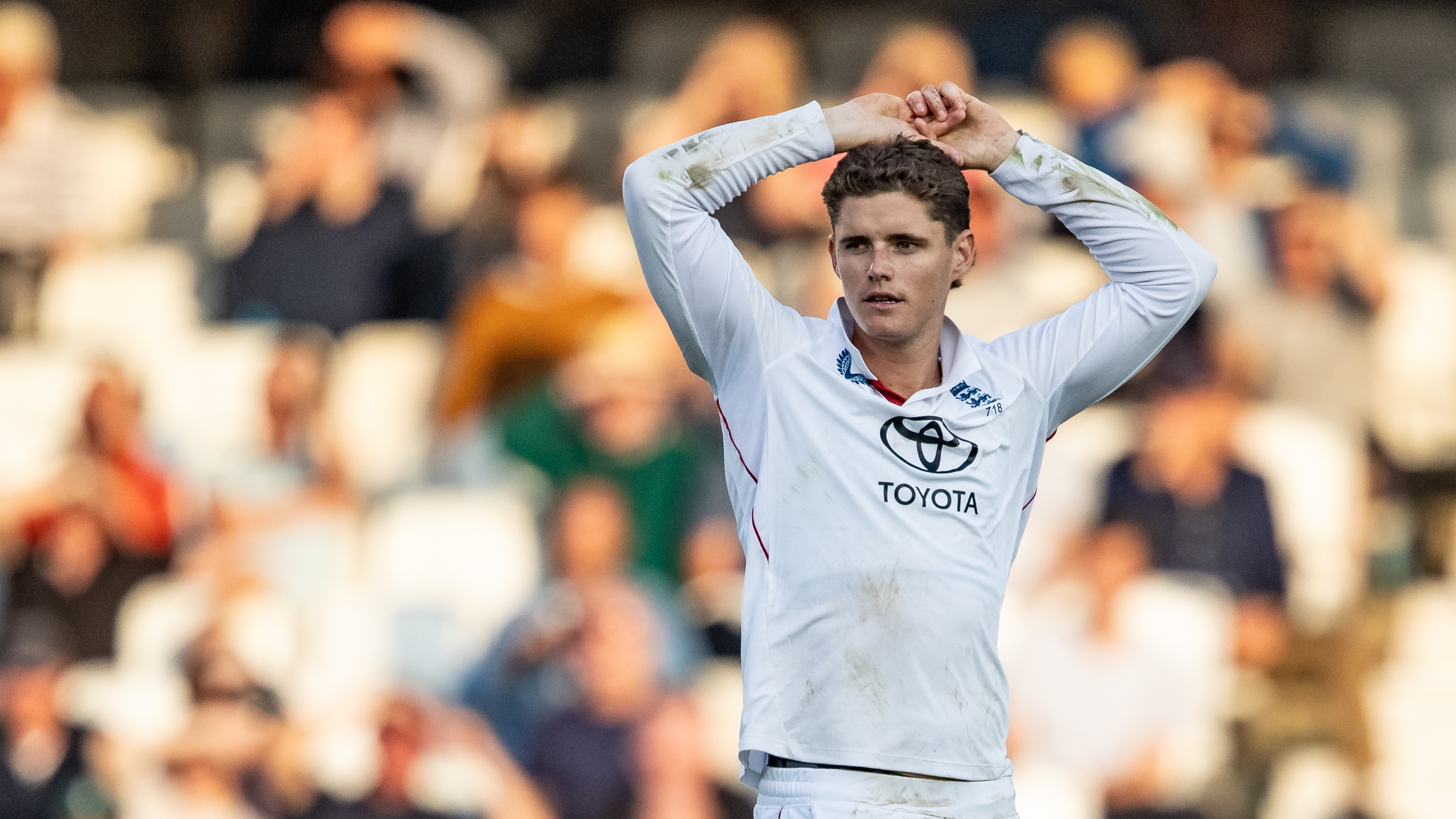 Jacob Bethell of England reacting to a near miss during a cricket match.