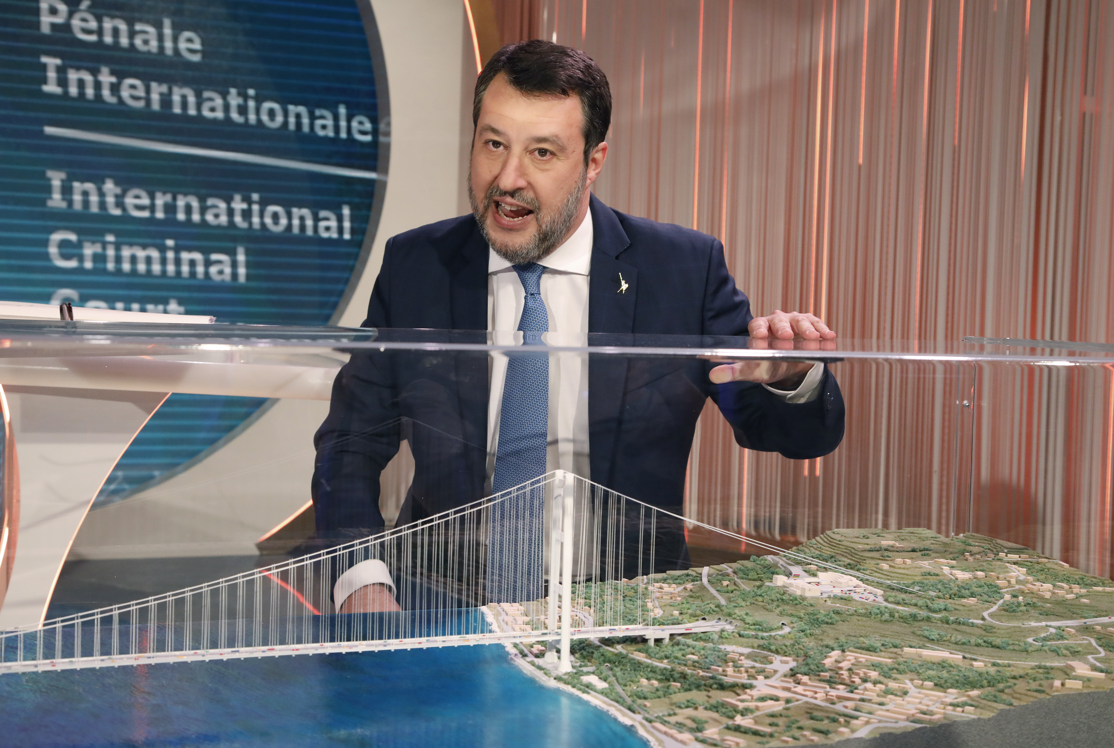 Matteo Salvini presenting a model of the Strait of Messina bridge on Italian TV.