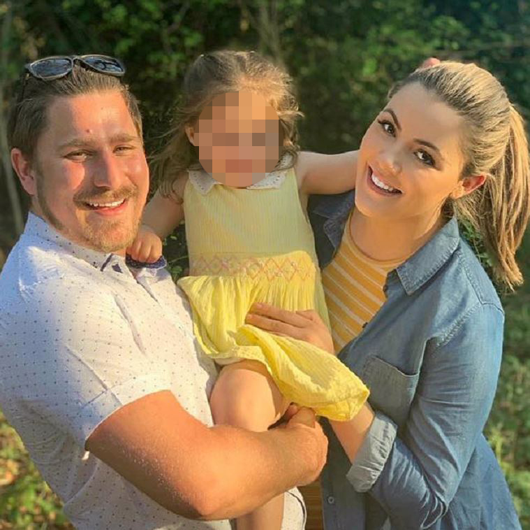 Photo of a family: a man, a woman, and a young child.