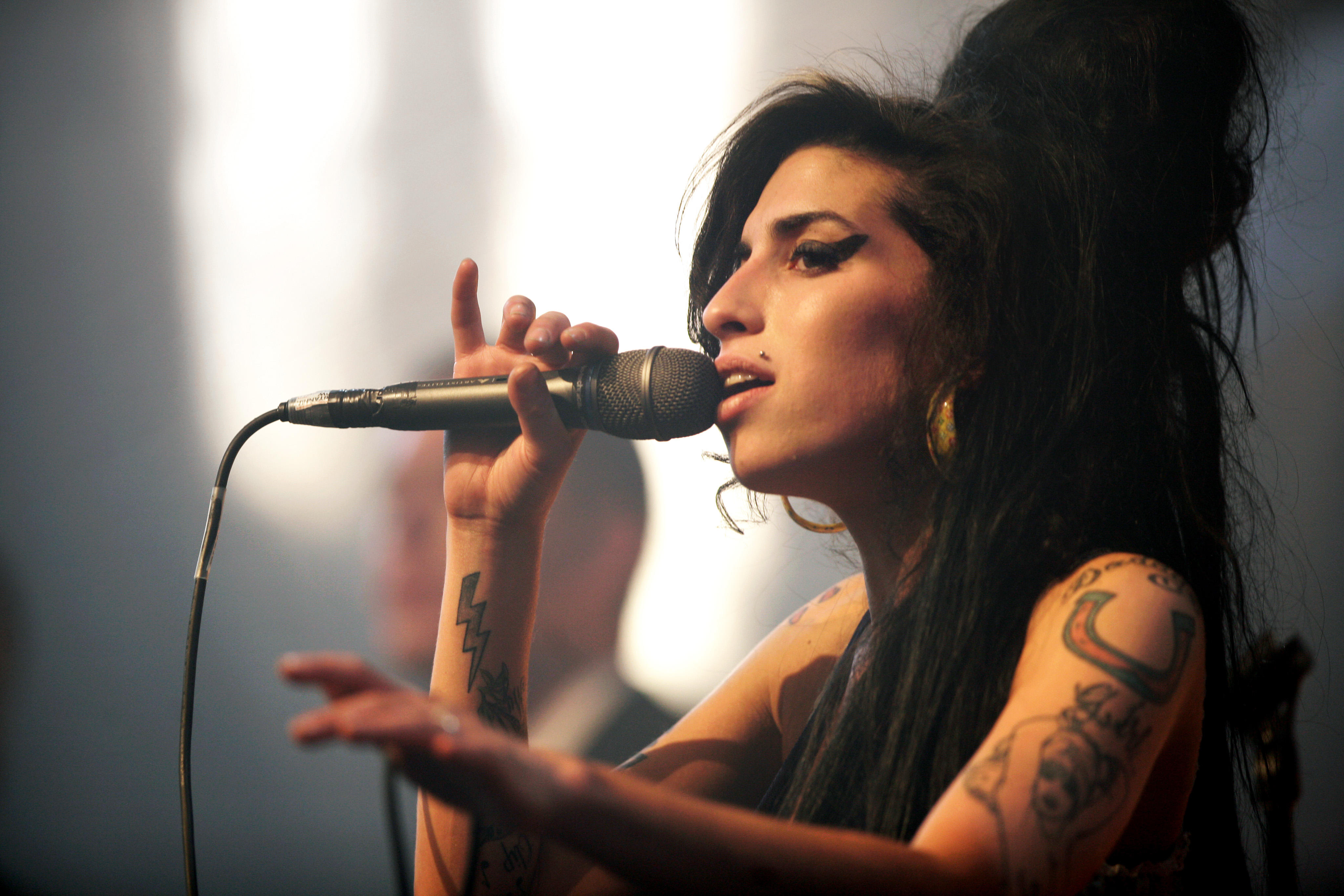 Amy Winehouse performing at a concert.