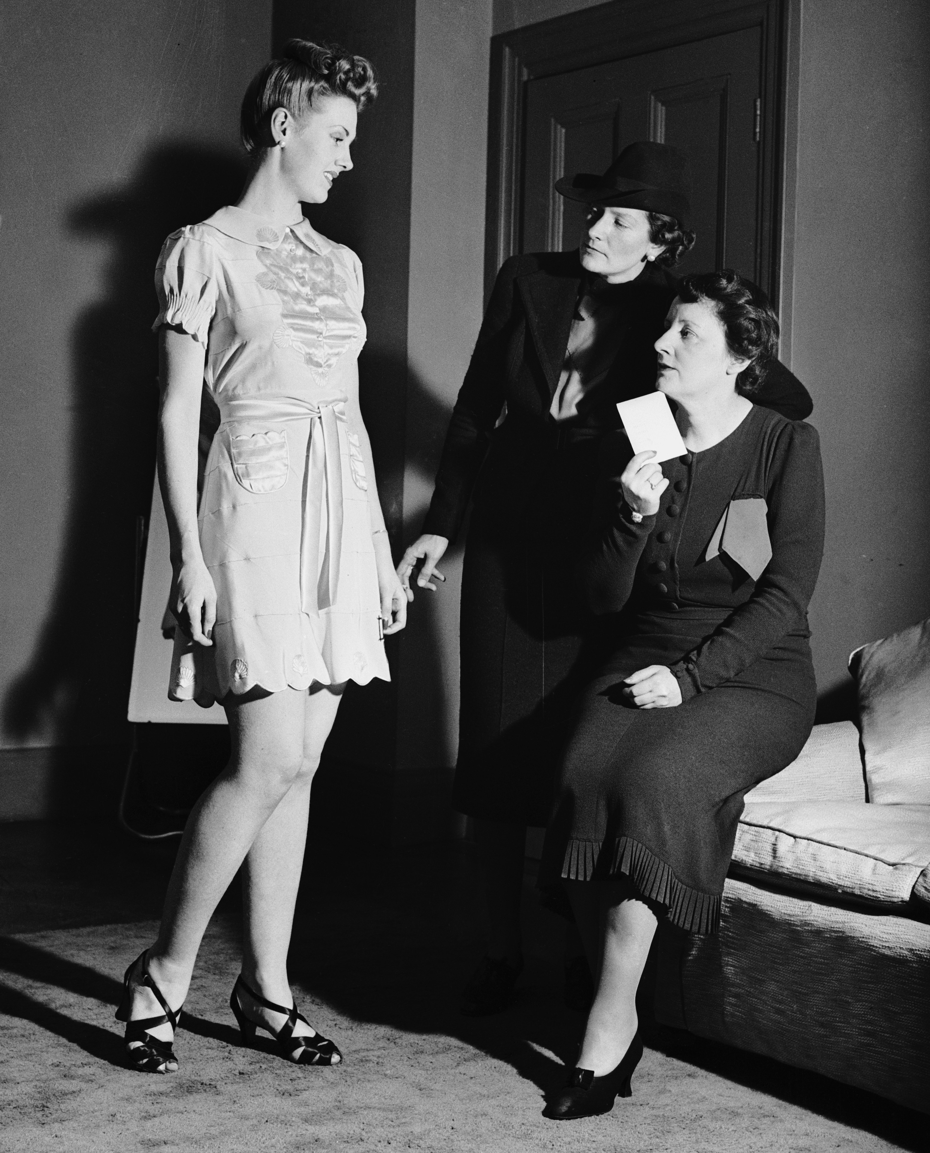 Lady Hart-Dyke inspecting a silk camisole.