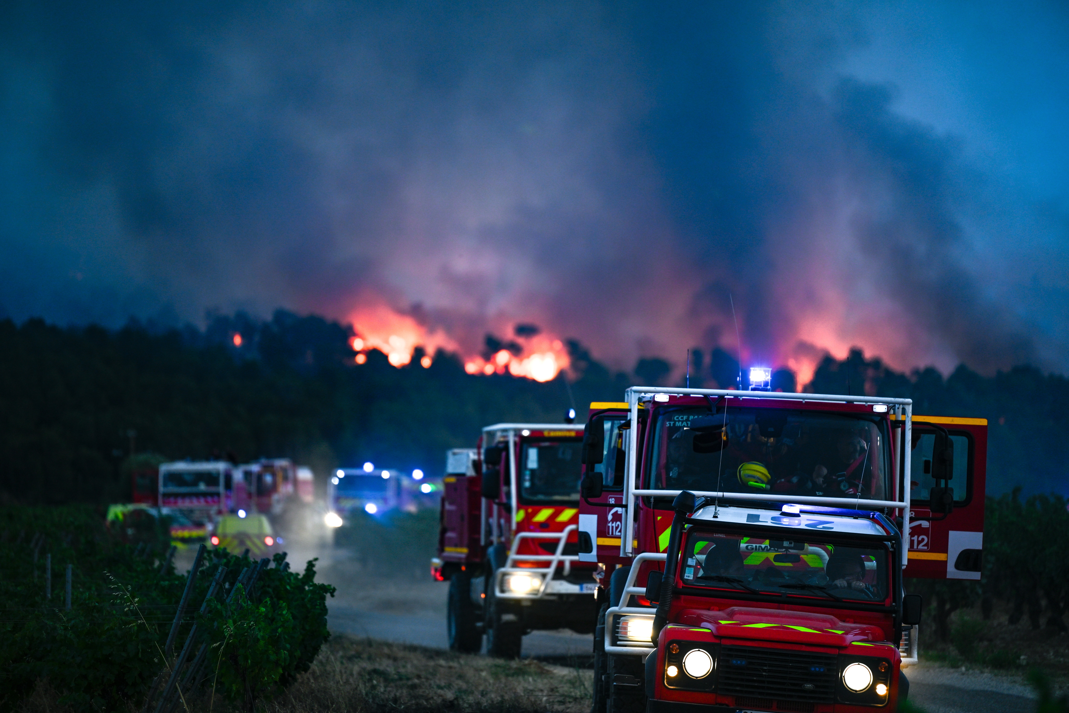 Firetrucks responding to a large wildfire in southern France.
