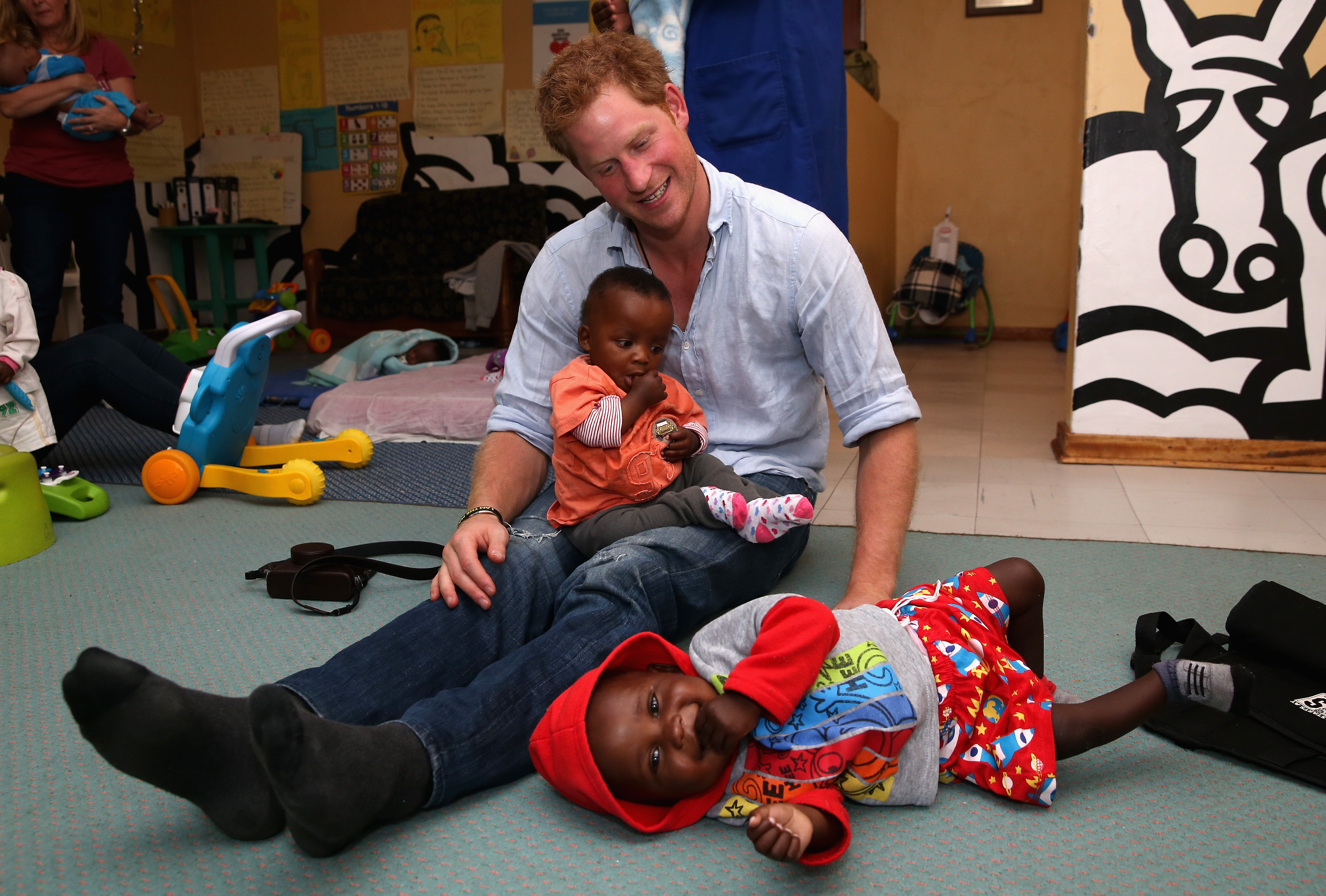 Prince Harry playing with malnourished children at a Sentebale-supported center in Lesotho.