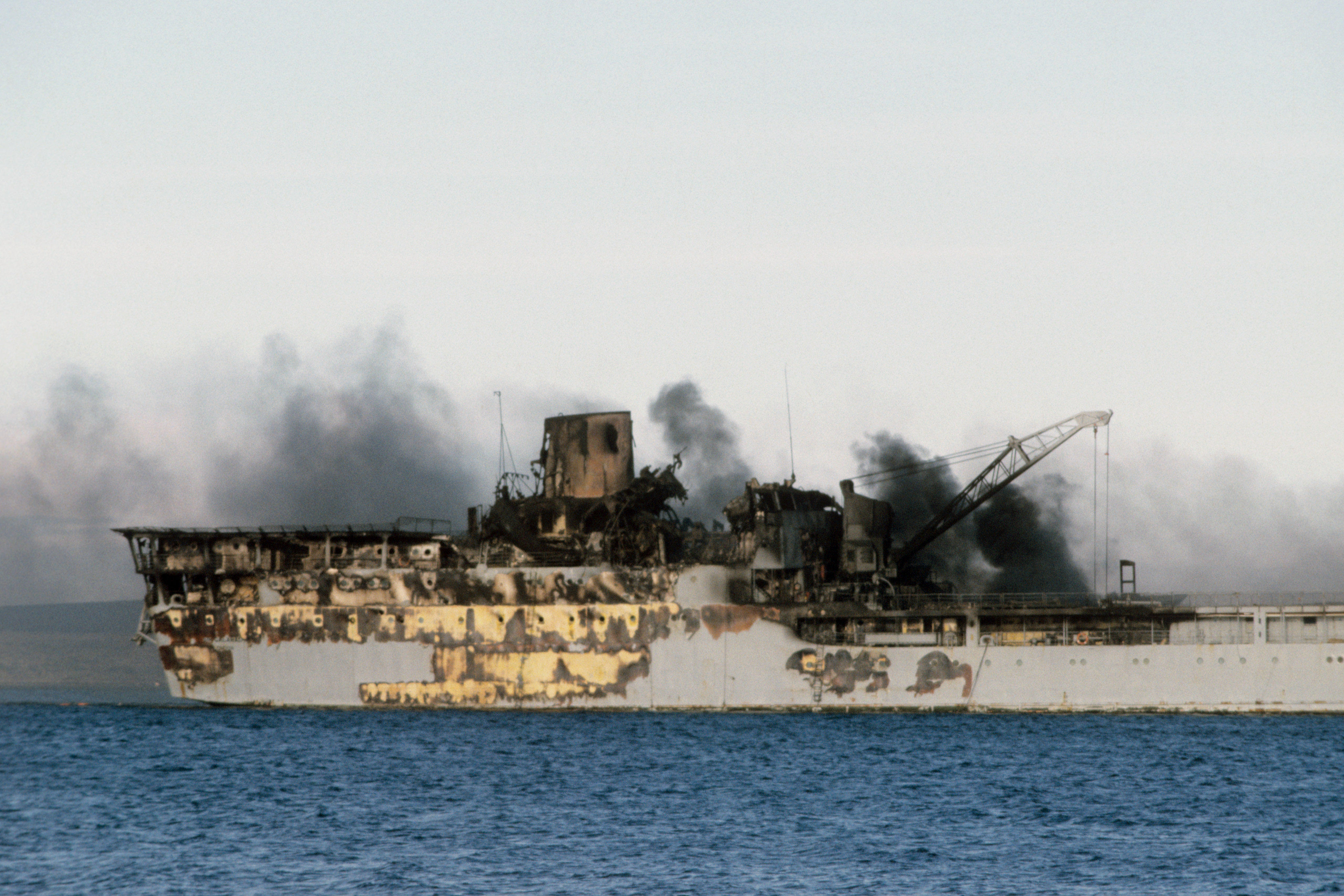 Smoke rises from the burning remains of the Sir Galahad.