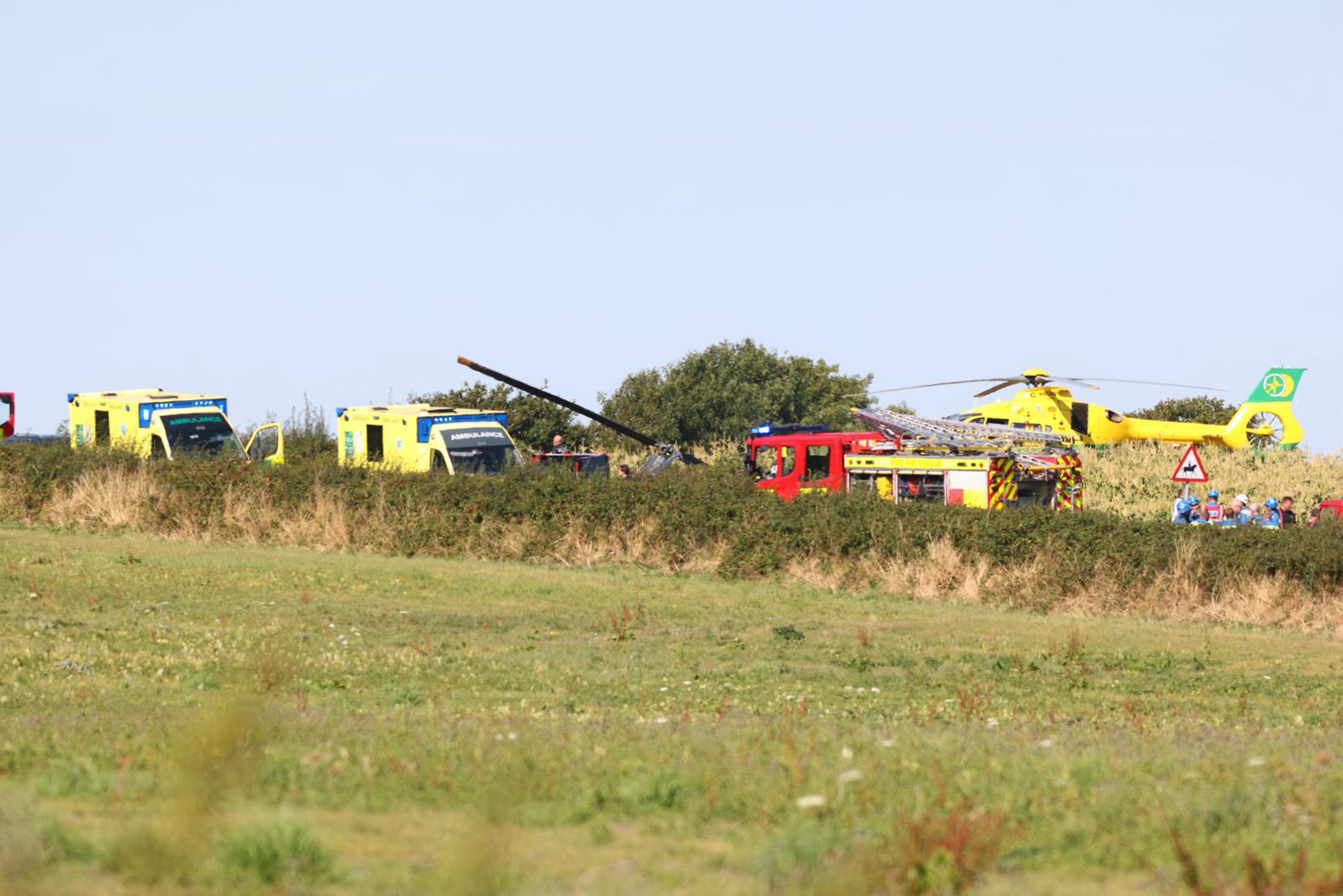 Emergency responders at a helicopter crash site.