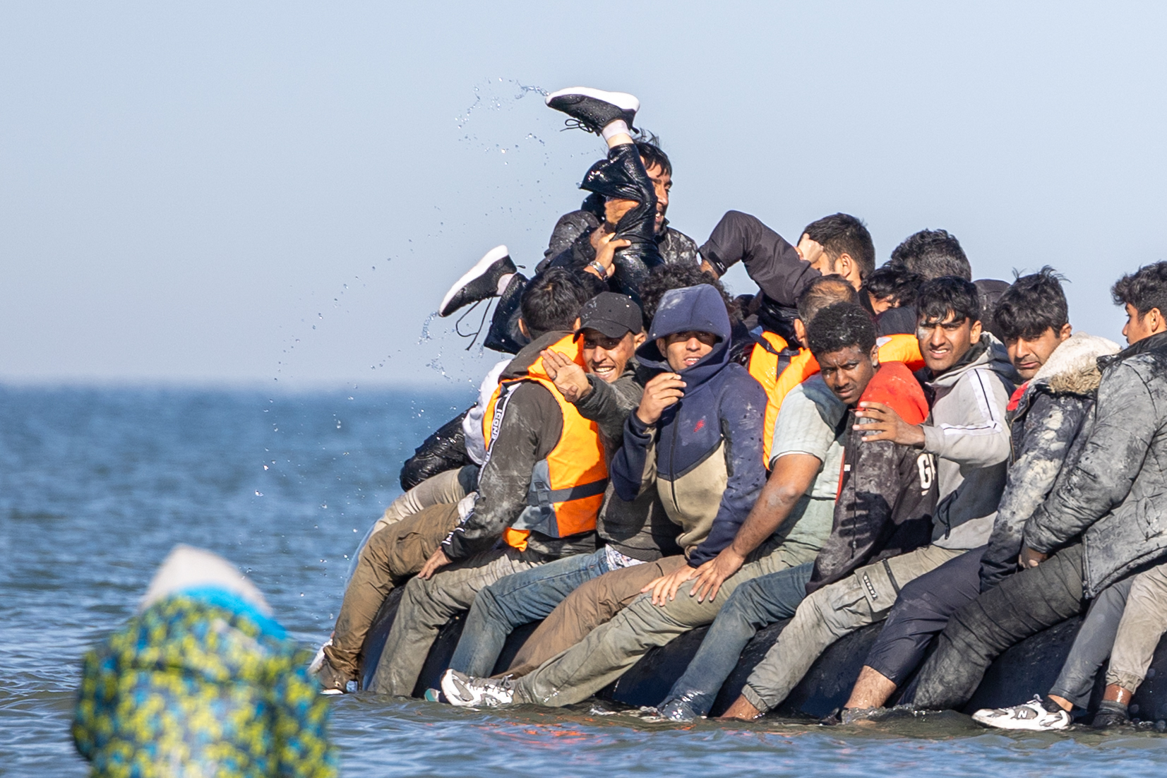Migrants in a small boat crossing the water.