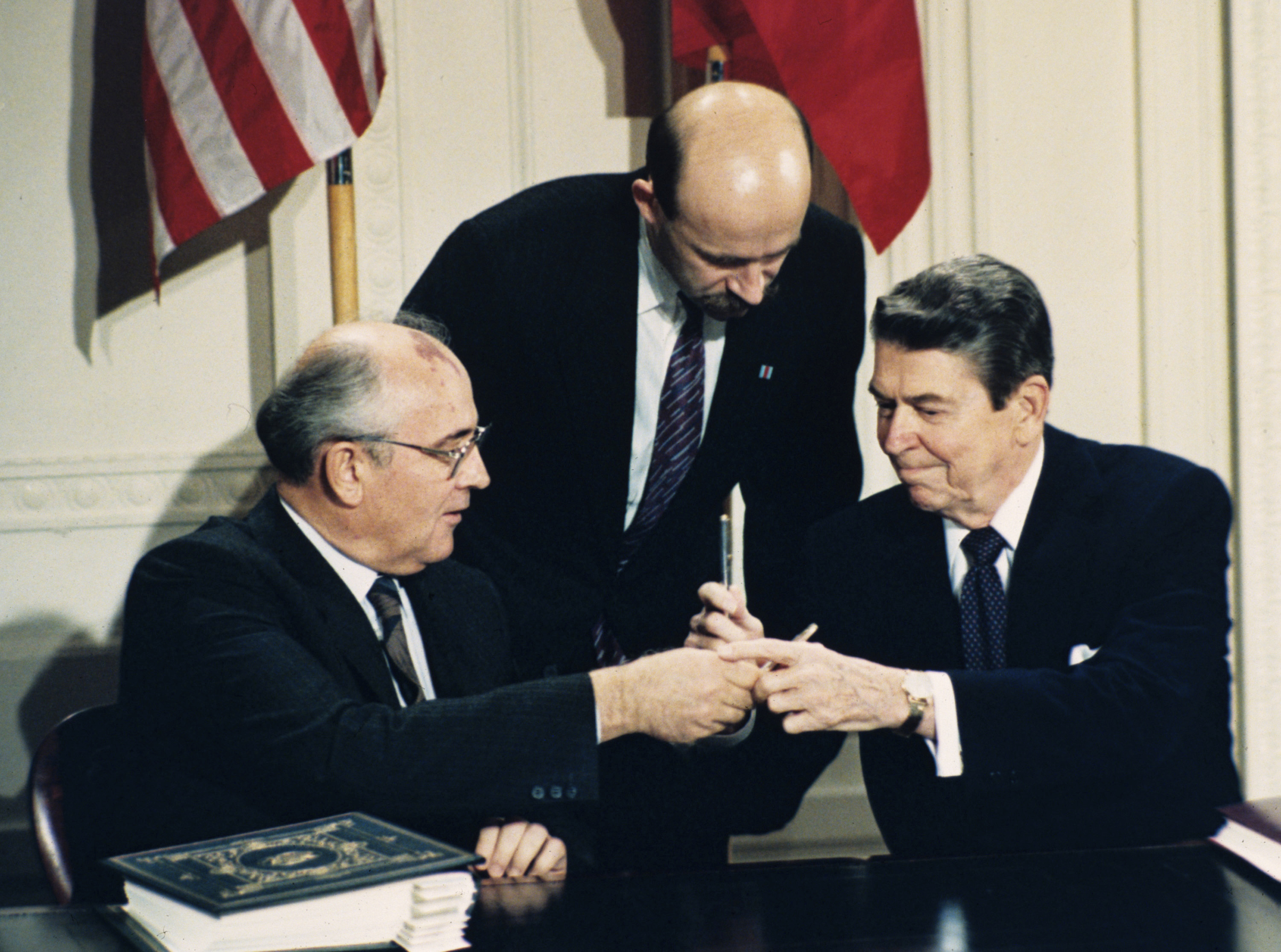 Reagan and Gorbachev exchange pens at the signing of the Intermediate-Range Nuclear Forces Treaty.