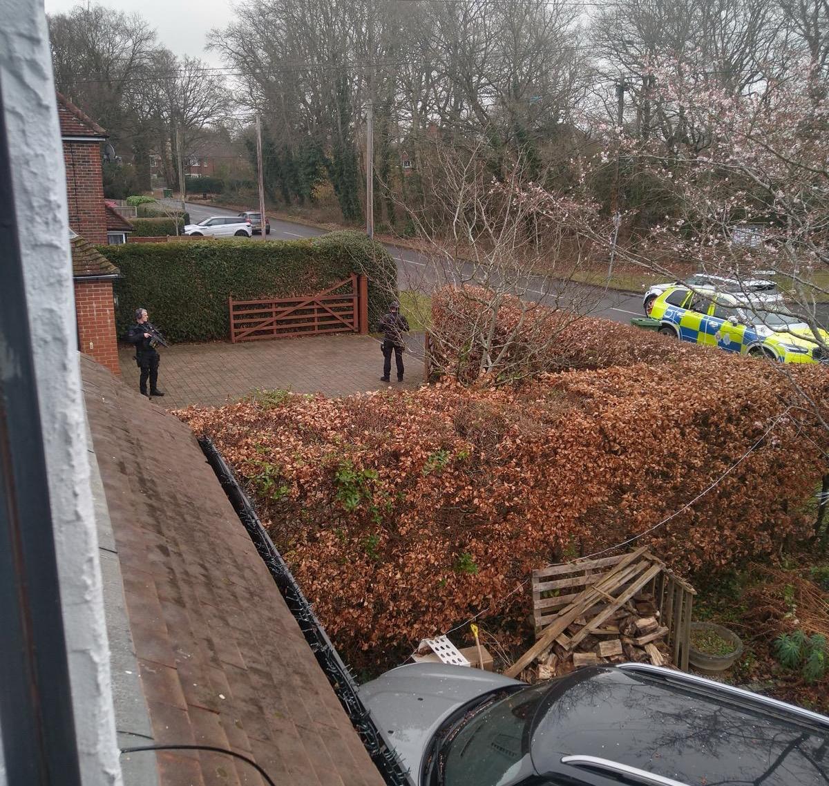 Armed police outside a house.