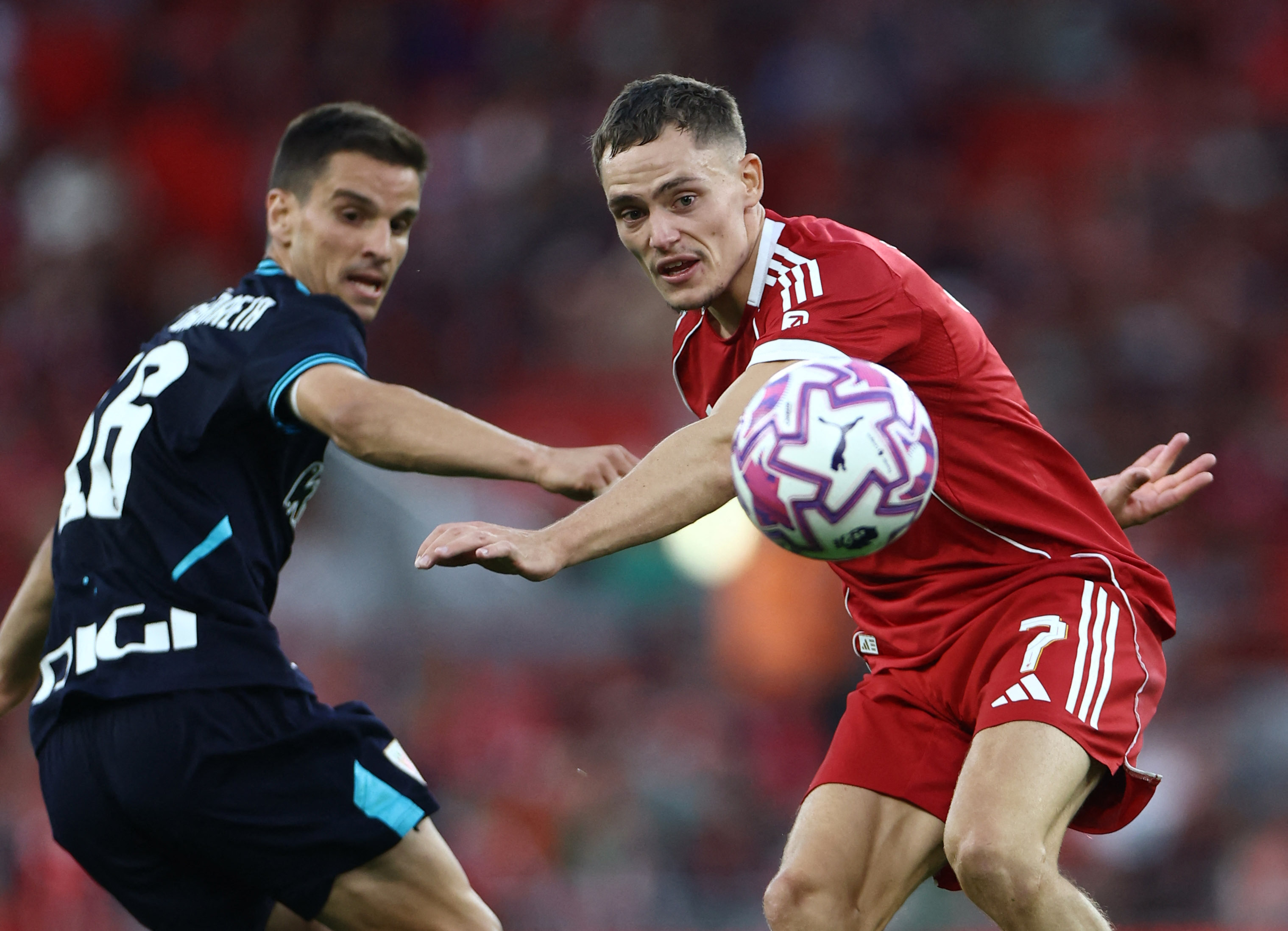 Liverpool's Florian Wirtz and Athletic Bilbao's Inigo Ruiz de Galarreta vying for the ball.