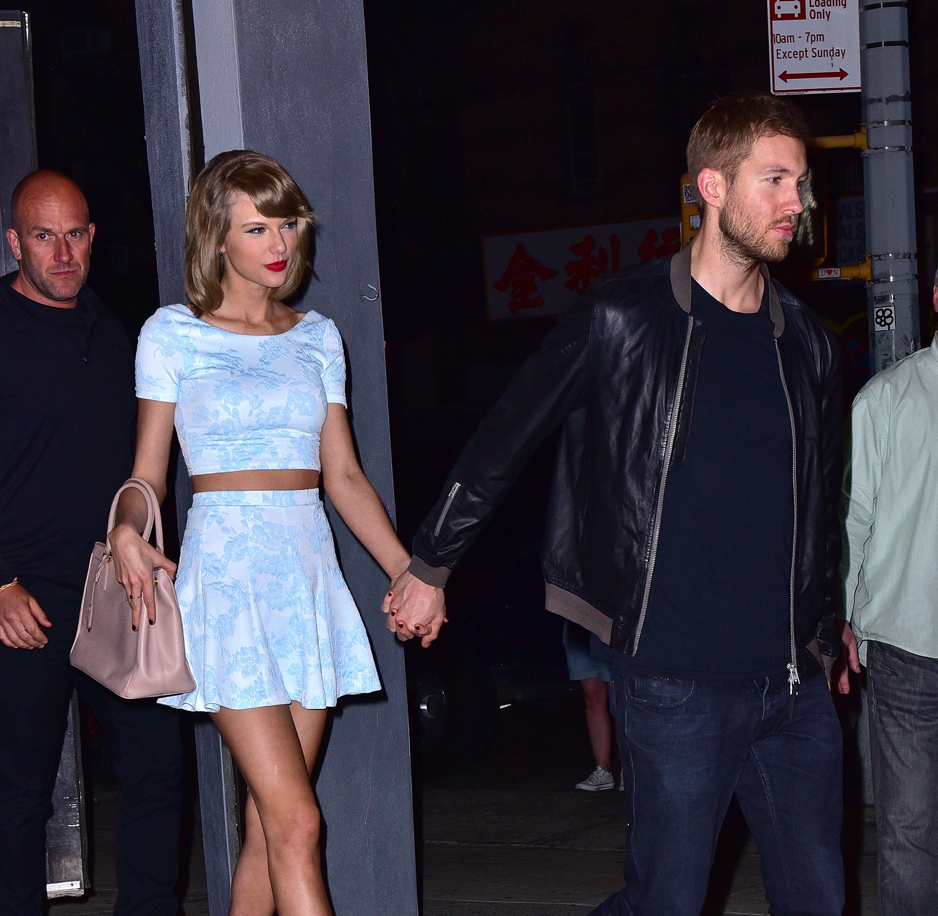 Taylor Swift and Calvin Harris holding hands leaving a restaurant in New York City.