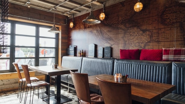 Wide shot of the interior of an empty seafood restaurant