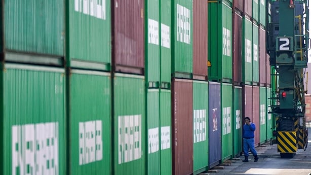 Stacked green shipping containers in a port