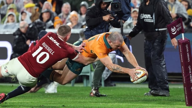 Australia's Dylan Pietsch (R) dives over to score 