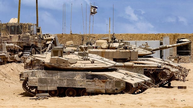 Israeli army main battle tanks are positioned near the border in Gaza