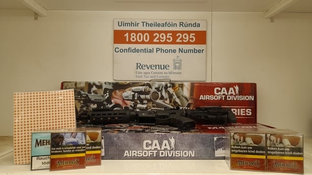 An airsoft gun and tobacco seized by Revenue on display