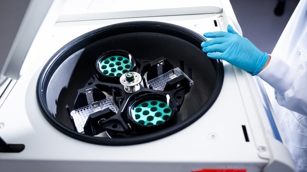 An laboratory workers uses medical equipment in a laboratory