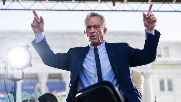 Robert F. Kennedy Jr waves his arms in the air 