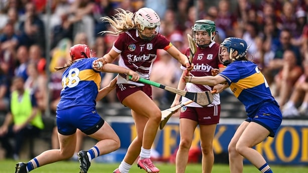 Olwen Rabbitte of Galway gets through the tackles of Aoife McGrath, left, and Julieanne Bourke of Tipperary - 2025 All-Ireland semi-final