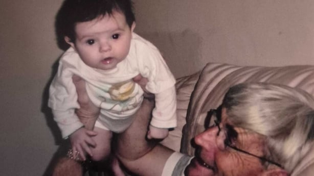 A baby being held by their father