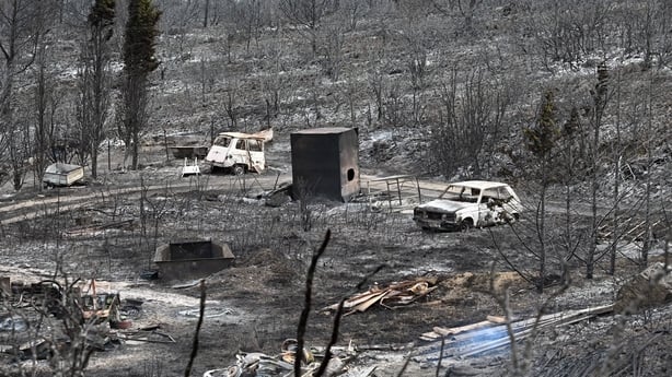 This photograph shows burnt cars in an area devastated by a wildfire near Fontjoncouse, southwestern France