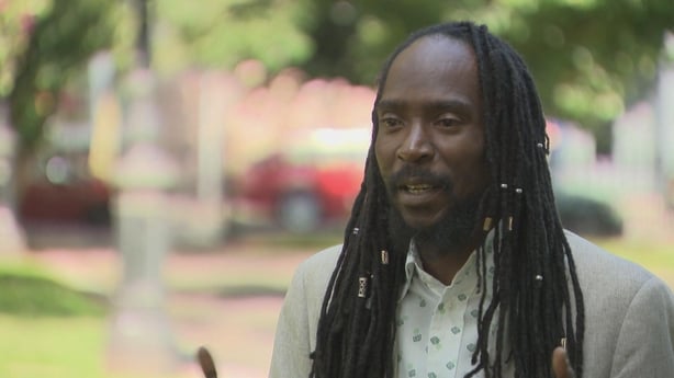 Takura Makoni of the African and Caribbean Support Organisation speaks to camera