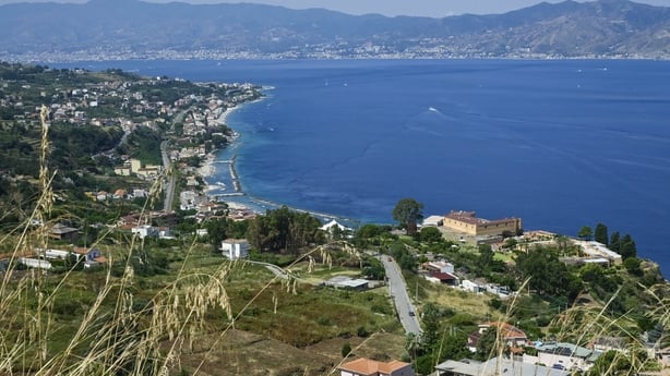 A view of green coastal area next to the sea off the coast of italy