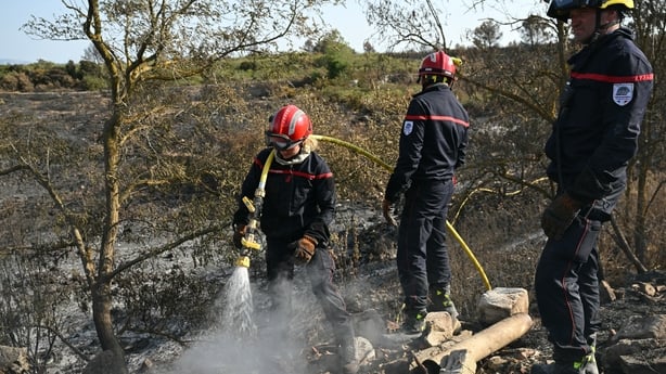 Firefighters put out hot ashes following wildfires in France