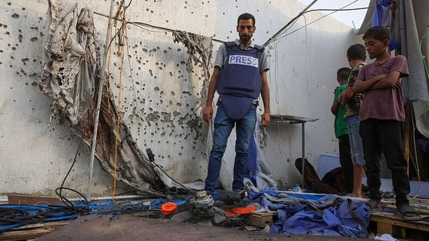 Palestinian children and a journalist check the destroyed Al Jazeera tent at Al-Shifa Hospital in Gaza City