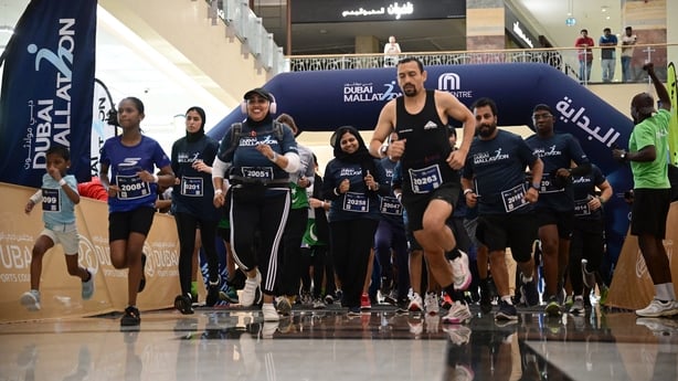 People take part in a run in a Dubai shopping centre