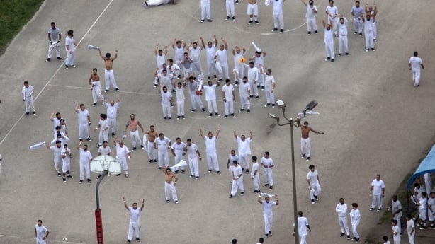 a group of men wearing white uniforms are seen in an aerial shot of a detention centre in Florida