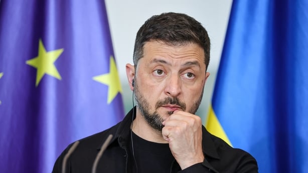 Ukrainian President Volodymyr Zelensky listens as German Chancellor Friedrich Merz (not pictured) speaks during a joint press conference at the Chancellery following a virtual meeting hosted by Merz between European leaders and U.S. President Donald Trump on August 13, 2025 in Berlin, Germany. The m