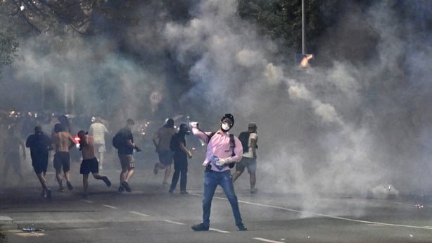 Demonstrators stand in clouds of tear gas during anti-government protesters in Belgrade