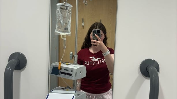 Caoimhe Graham takes a mirror selfie while in hospital