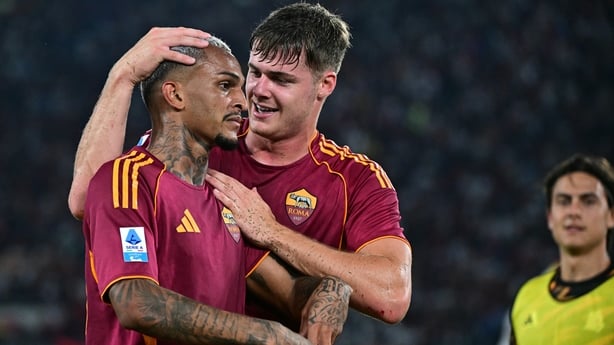 Roma's Brazilian defender #43 Wesley celebrates with teammate Roma's Irish forward #11 Evan Ferguson after scoring his team's first goal during the Italian Serie A football match between AS Roma and Bologna at the Olympic Stadium in Rome on August 23, 2025. (Photo by Tiziana FABI / AFP)