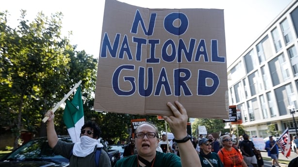 A demonstrator holding a 'No National Guard' sign in a protest organised by the Free DC movement in Washington, US 
