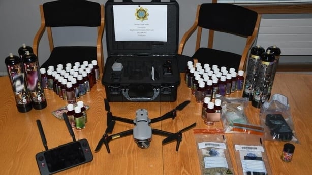 A drone and bottles of liquid THC on a table
