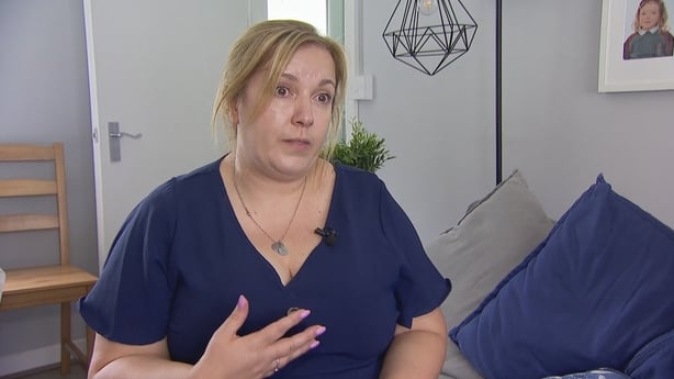 Rachel Lowry sits on a couch.