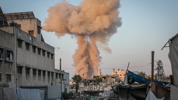 Smoke and dust rise over residential areas after an Israeli airstrike on Gaza City