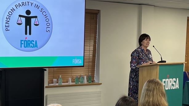 School secretary Luisa Carty speaks on stage at a meeting at Fórsa headquarters